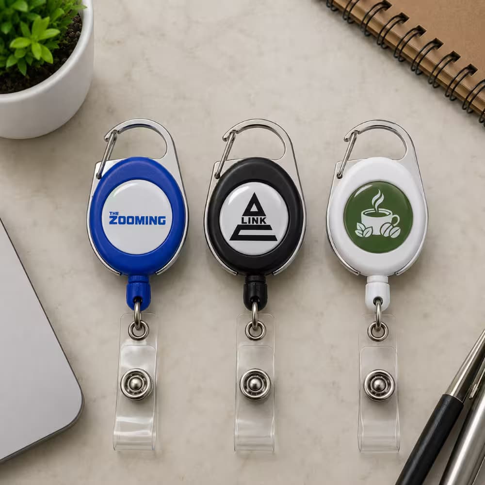 Custom retractable badge reels available in blue, black, and white with carabiner clips