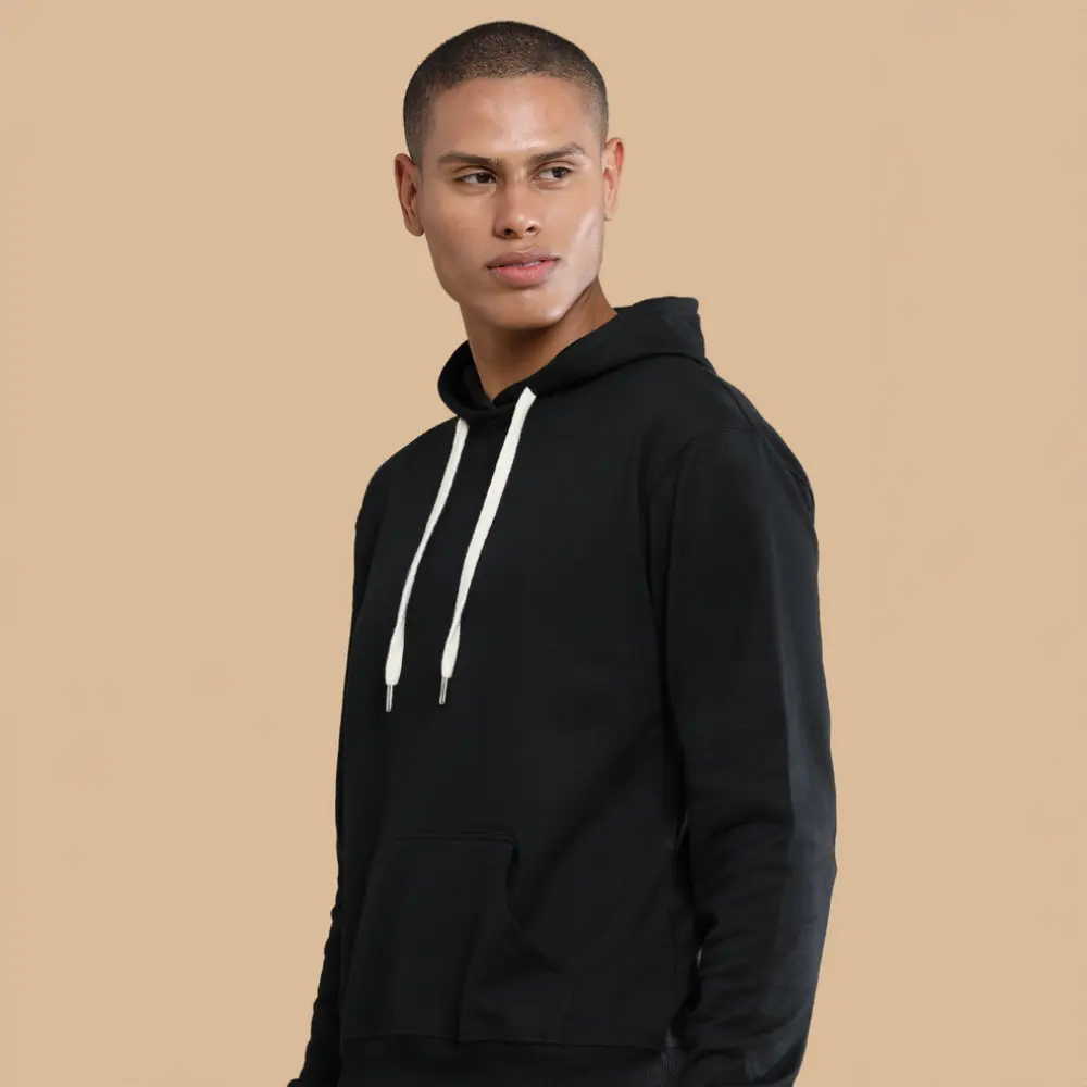 A man wearing a black hoodie with white drawstrings