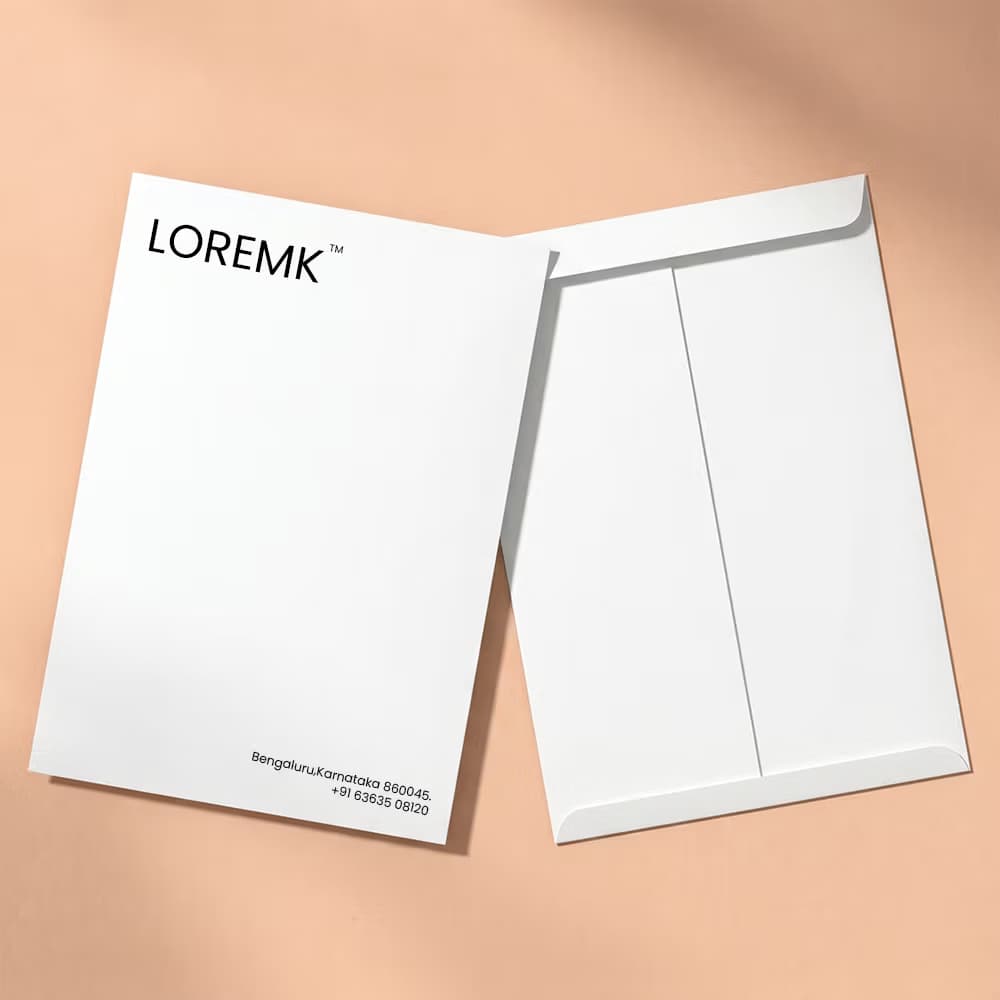 Front and back view of a white A5 envelope featuring the "LOREMK" logo and contact details, against a beige background.