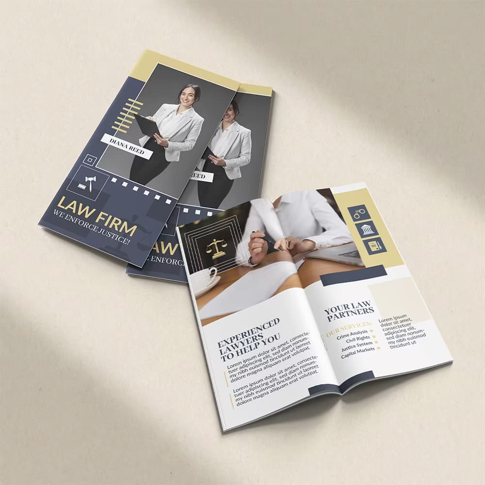 A booklet for a law firm displayed both closed and opened to its service pages on a textured cream background with soft shadows.