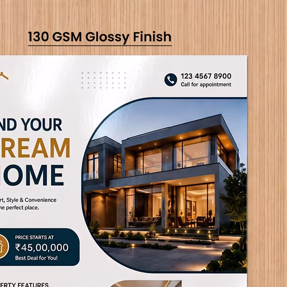 Close-up of a printed real estate flyer showing a light-reflecting 130 GSM glossy finish.