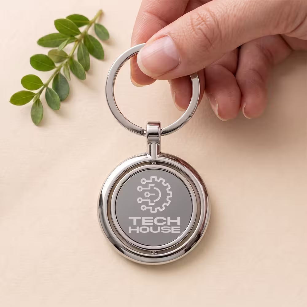 tech house logo engraved spinning metal keychain in hand