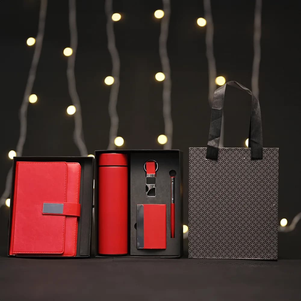 5-in-1 corporate gift set in a black box with a white notebook, thermos, accessories, and a matching gift bag.