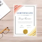 laminated certificate for Tanya Kumari with peach and gold silk drapes on a light wood desk background.