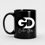Custom black mug with GD Creative Studio logo in bold white typography, perfect for personalized branding merchandise.