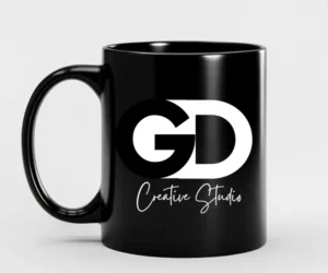 Custom black mug with GD Creative Studio logo in bold white typography, perfect for personalized branding merchandise.