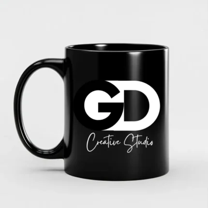 Custom black mug with GD Creative Studio logo in bold white typography, perfect for personalized branding merchandise.
