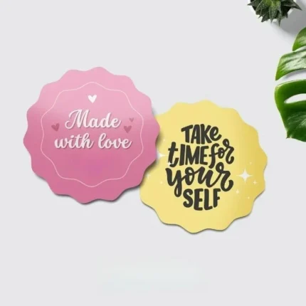 Scalloped-edge custom stickers with vibrant designs. Pink sticker reads 'Made with love,' ideal for gifting, while the yellow sticker says 'Take time for yourself,' perfect for personal use. Great for branding, events, and DIY projects.