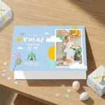 A blue sky-themed birthday card for Payal, featuring a baby photo, a circus tent, birds, and gift boxes.