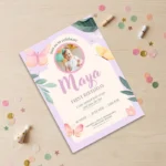 A purple butterfly-themed first birthday invitation for Maya, featuring a baby photo and floral accents.