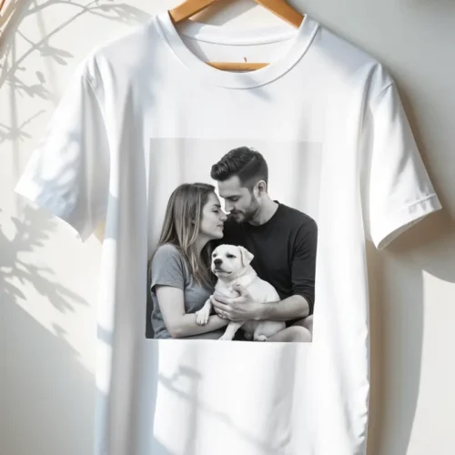A white T-shirt featuring a centered, black and white photo of a couple lovingly holding a white puppy. Best T-Shirt Design Ideas