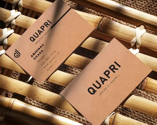 Eco-Friendly Business Card by Quapri made with kraft paper and minimalist black text design.