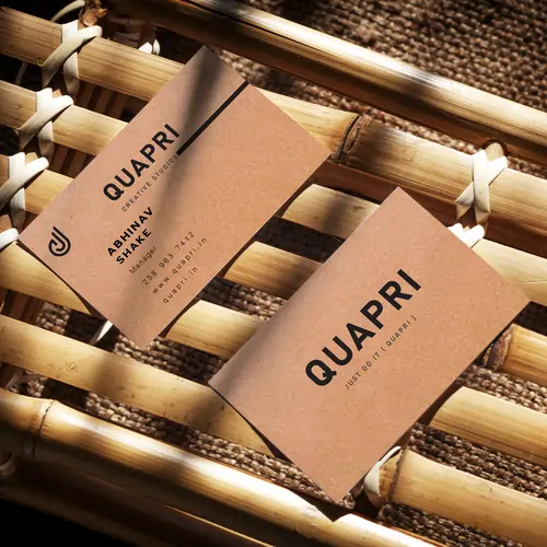 Eco-Friendly Business Card by Quapri made with kraft paper and minimalist black text design.