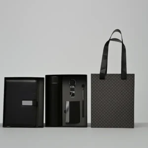 Employee Welcome Kit: Deluxe five-piece black gift set: a diary, thermos bottle, keychain, cardholder, and stylus pen, with a matching patterned gift bag.