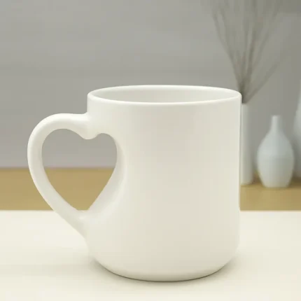 White ceramic custom mug with heart-shaped handle.