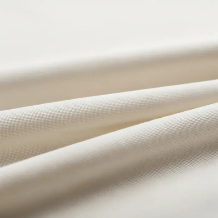 Soft, off-white cotton fabric with visible folds and a subtle weave texture, ideal for Personalized T-Shirt Printing that prioritizes a comfortable, quality feel.