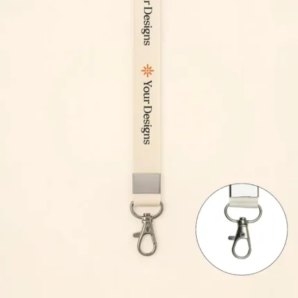 Cream-colored custom lanyard with side lever hook, printed “Your Designs,” small orange icon, and metal clasp for ID cards or keys.