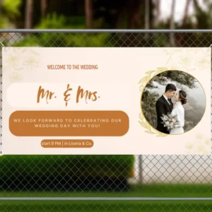 Wedding banner displayed on a fence, featuring “Mr. & Mrs.” text, a photo of the couple, floral accents, and details about the celebration time and venue.