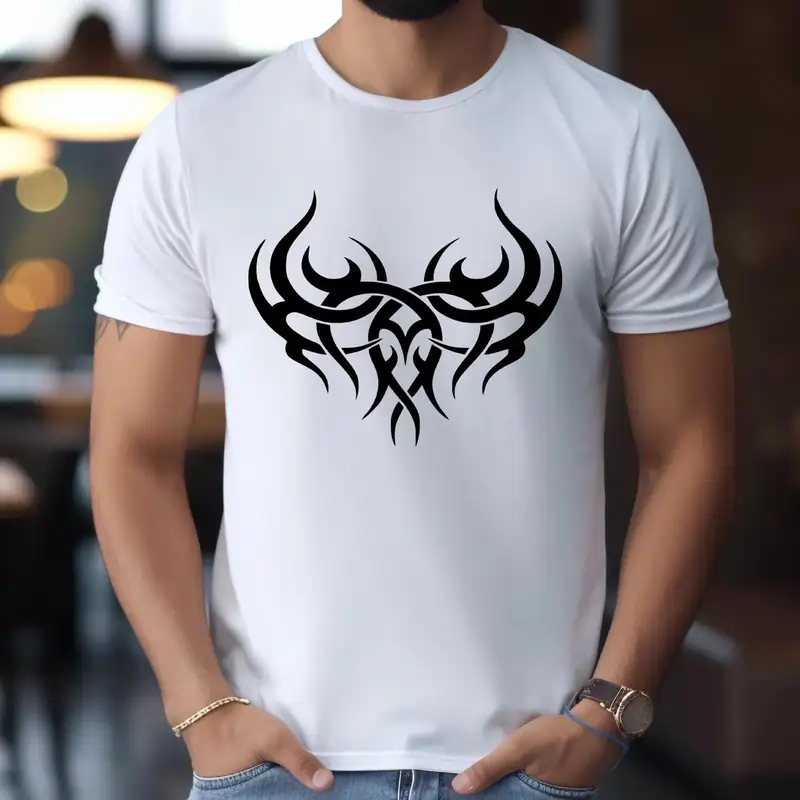 A white T-shirt on a man, featuring a black tribal-style graphic design centered on the chest. Best T-shirt Design Ideas.