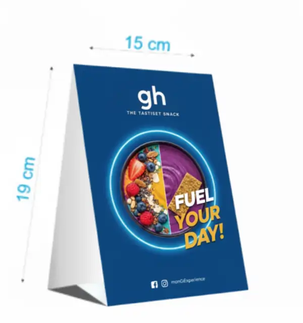 A blue A-frame table tent for "gh THE TASTIEST SNACK" measuring 15 cm by 19 cm, featuring a smoothie bowl.