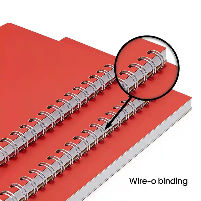 Close-up of double-loop metal Wire-o binding on red notebooks, highlighting the professional, secure twin-wire style.