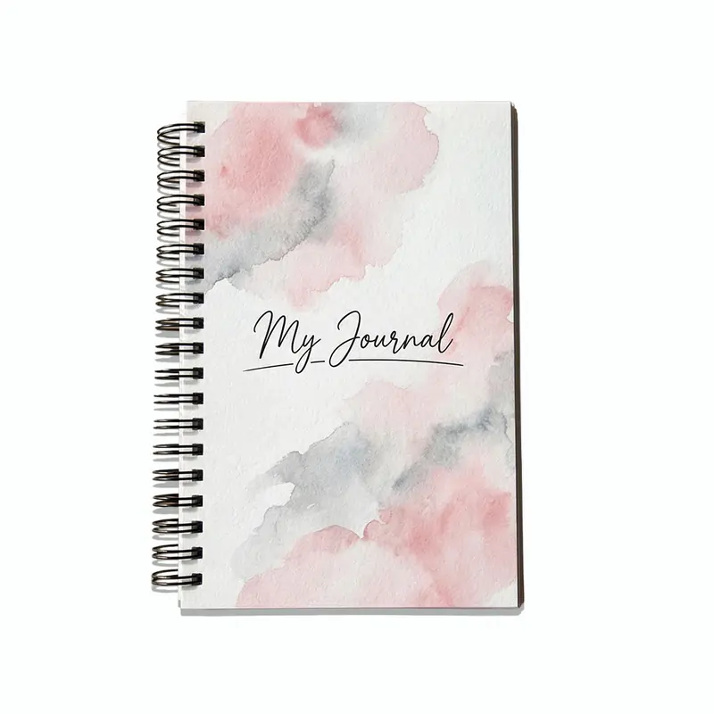 A spiral-bound aesthetic notebook with a pink and grey watercolor cover and the words "My Journal" in cursive.